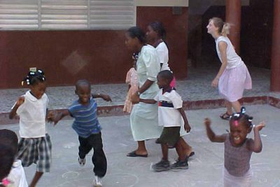 Abby playing with the kids in the school yard.