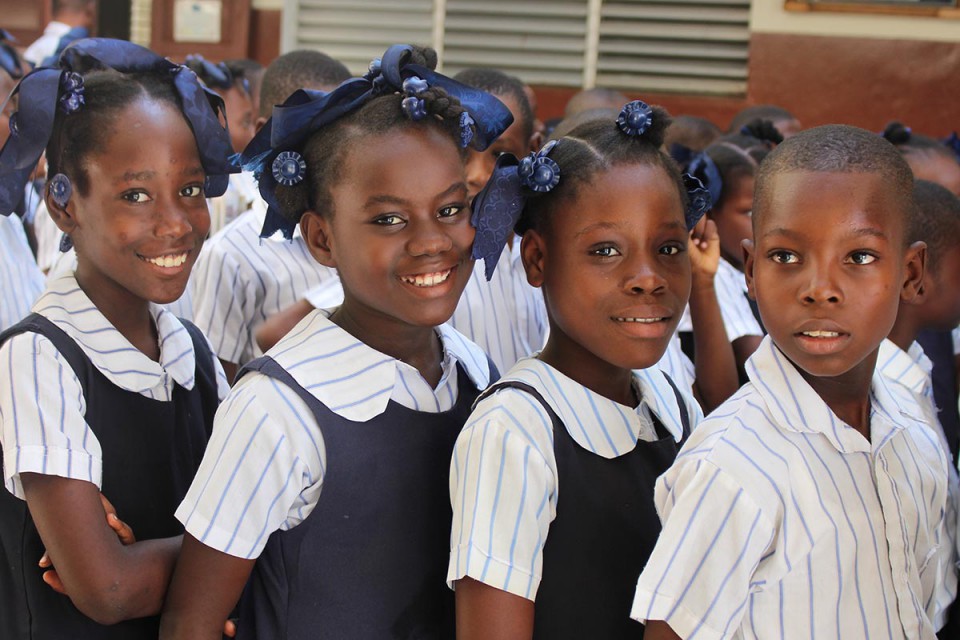 Four Primary School Children Smiling